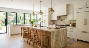 Kitchen remodel ideas featuring a large white oak island with quartzite countertop and neutral perimeter cabinets